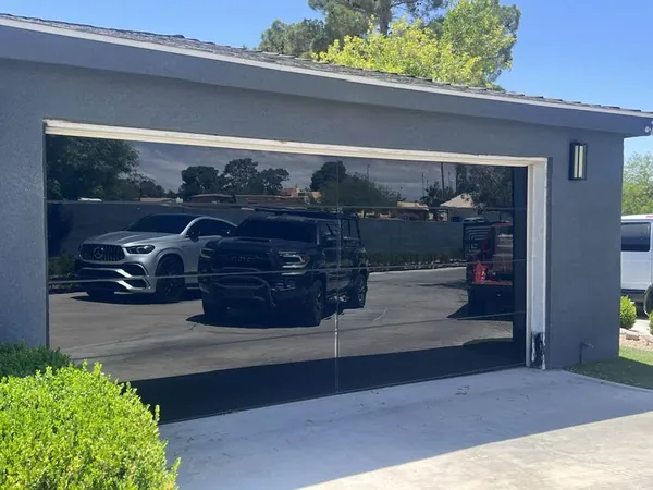 Modern black full-view glass garage door installed on a Las Vegas home