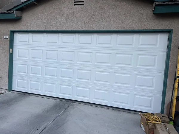 White sectional double garage door installed in the valley