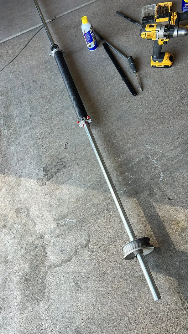 Torsion spring assembly above a garage door