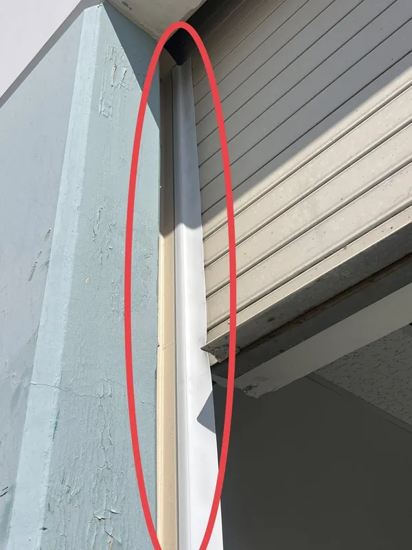 Damaged garage door panel marked for repair