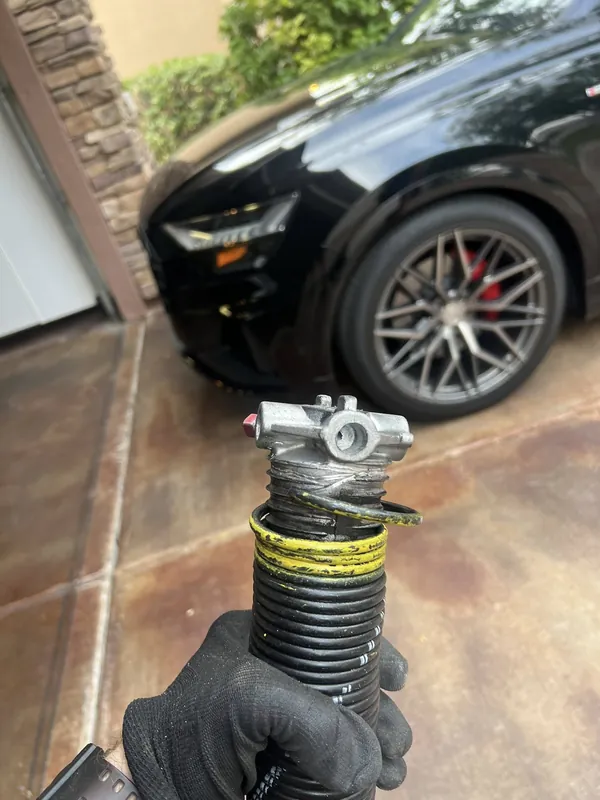 Lubricating and adjusting garage door rollers